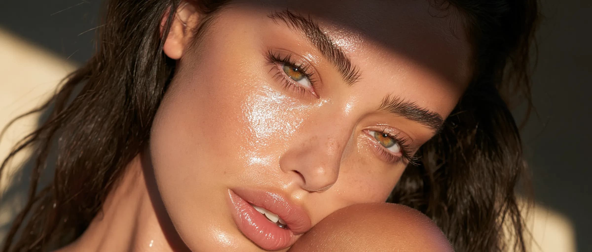 A woman turned toward the light, skin calm and evenly hydrated