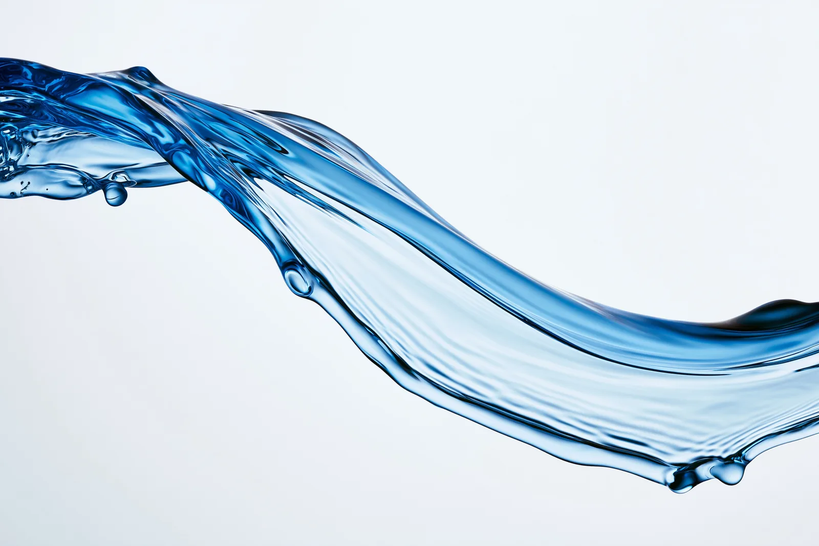 A stream of translucent blue serum against porcelain white
